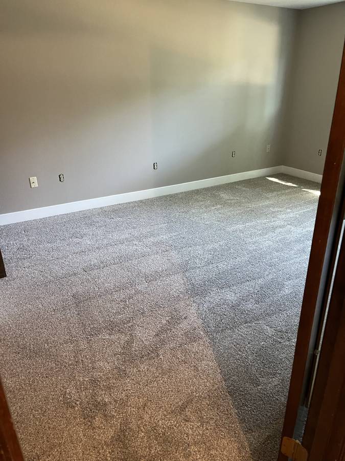 Bedroom with new carpet, paint and baseboards