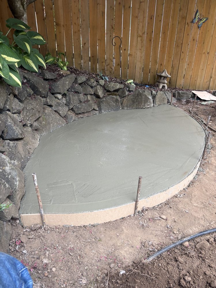 Concrete poured and floated inside the curved patio forms