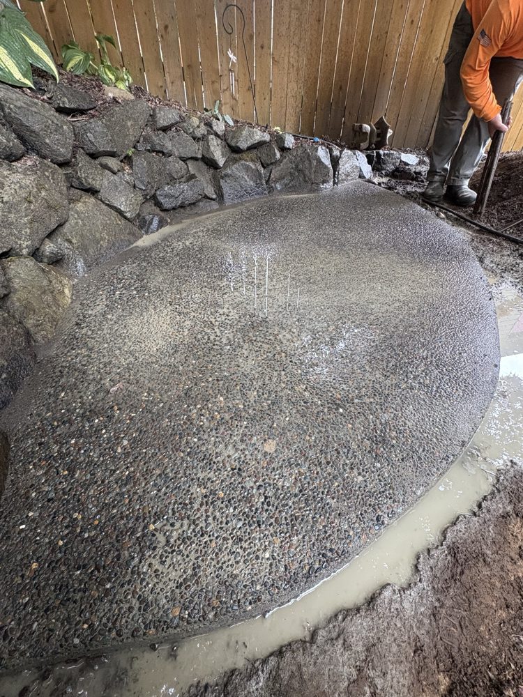 Exposed aggregate finish revealed on the new curved patio