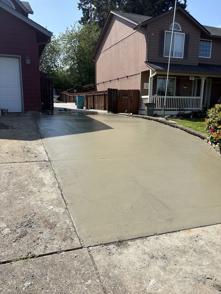 New driveway pour next to the garage, freshly floated