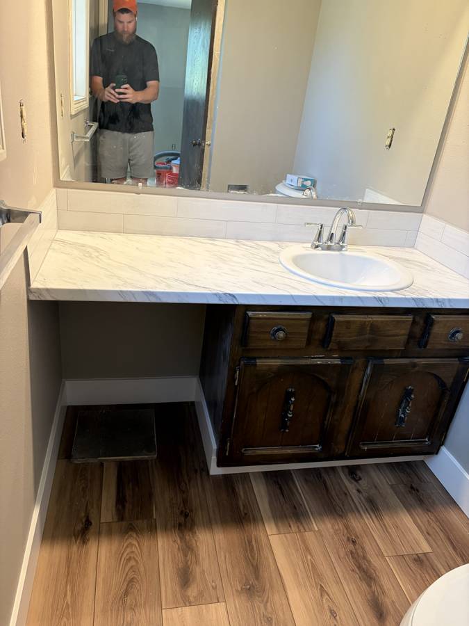 Bathroom vanity with new countertop, faucet, backsplash and flooring