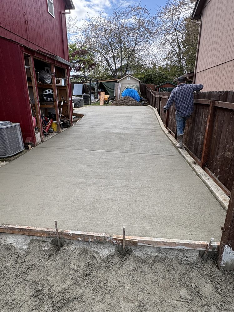 Driveway extension poured along the side yard to the back
