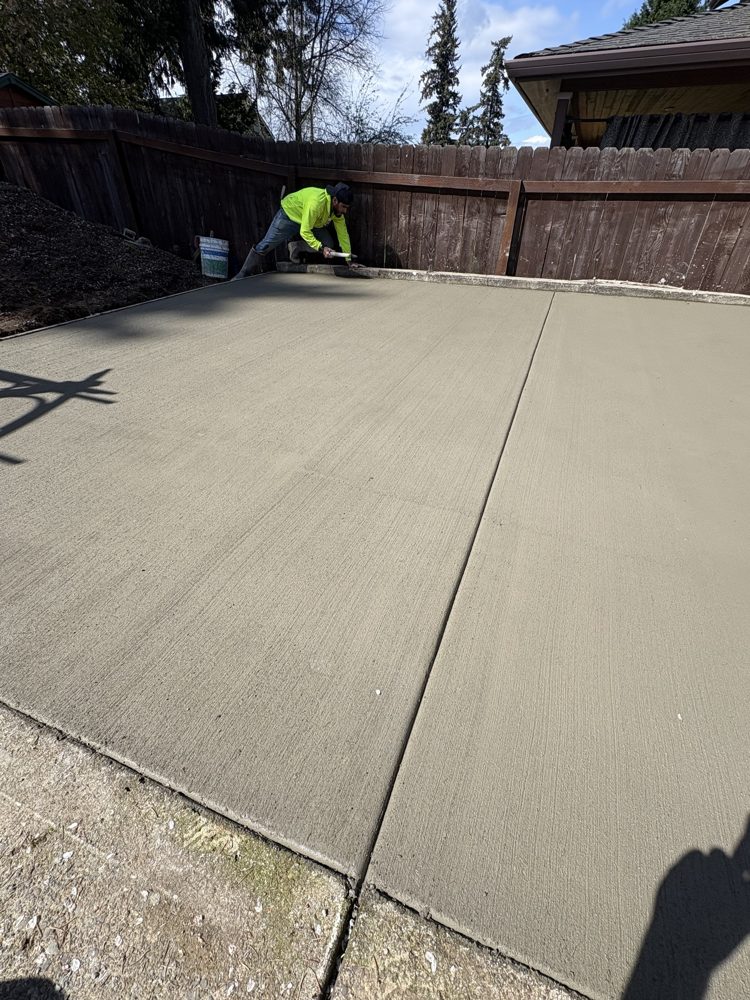 Crew edging the new slab with broom finish and control joint