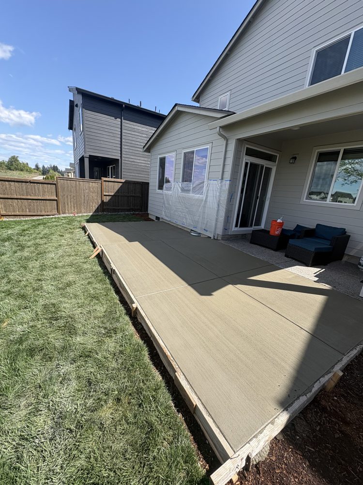 New broom-finish backyard patio poured off the covered porch