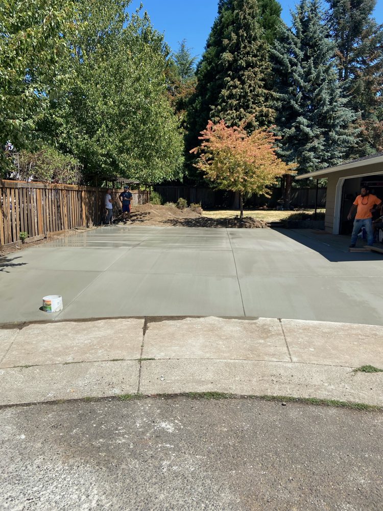 New two-car-wide driveway poured with control joints, seen from the street