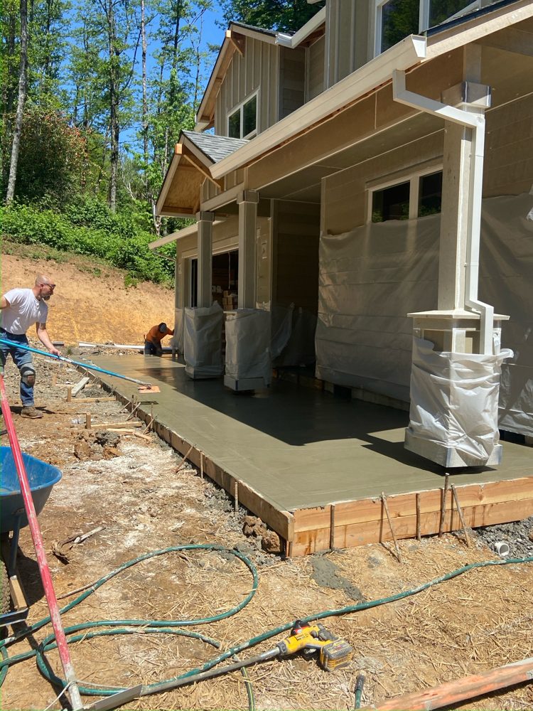 Bull-floating a new porch slab on a new-construction home