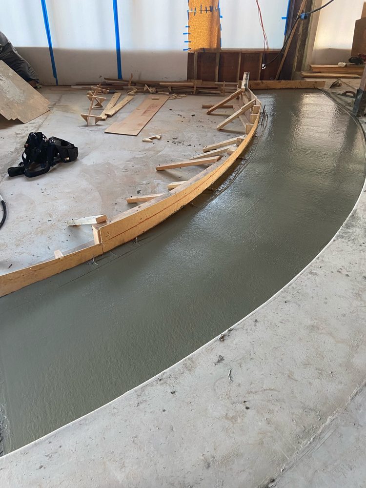 Curved concrete pour formed inside a commercial build-out
