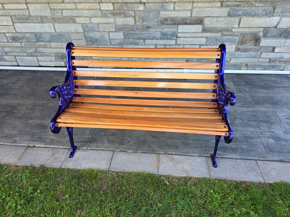 Restored cast iron park bench in gloss cobalt blue with new hardwood slats