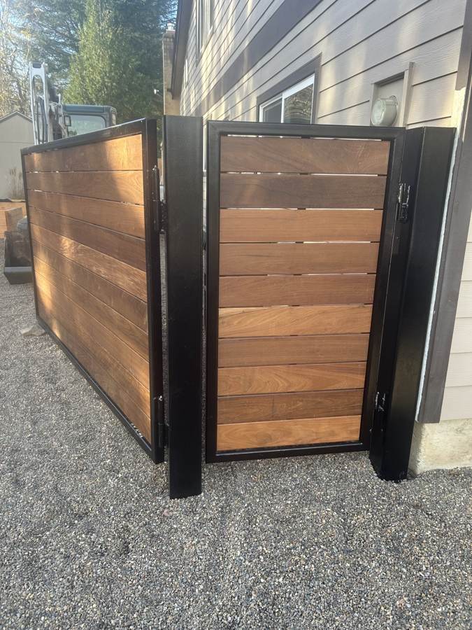 Hardwood slat gates in black steel frames, closeup