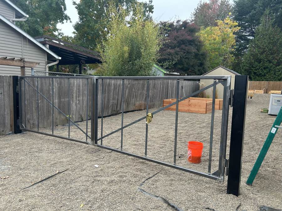 Double steel drive gate during installation