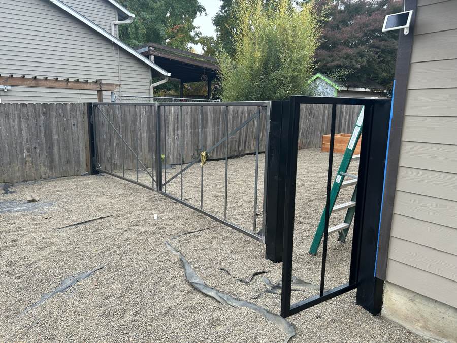 Steel drive gates and walk gate during installation