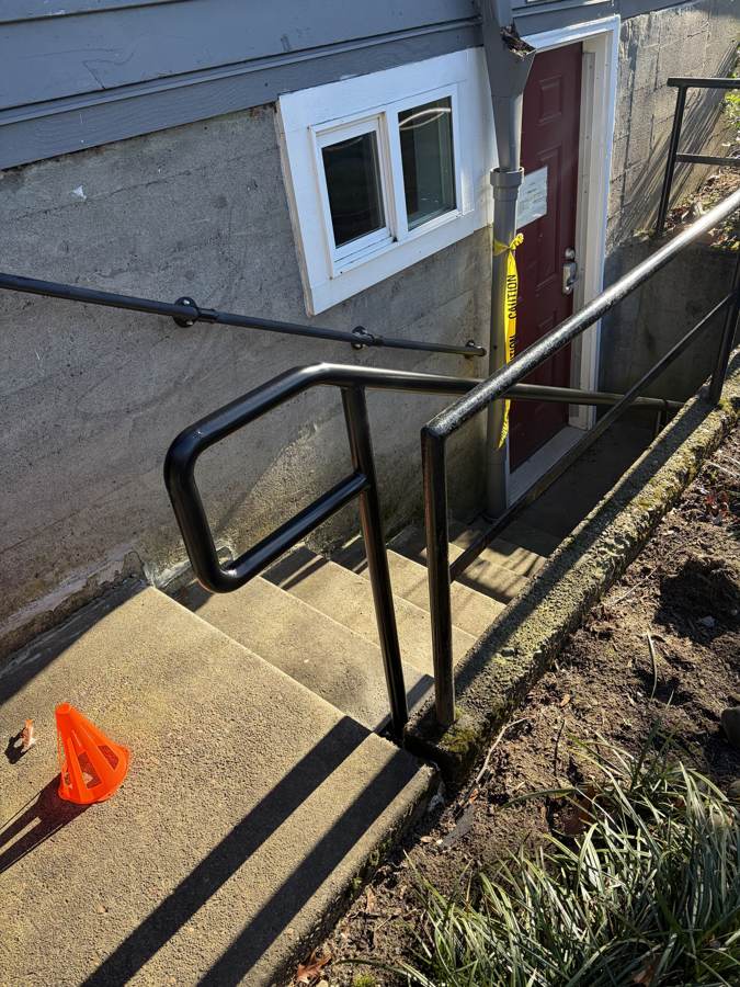 New black steel handrail at a basement stairwell