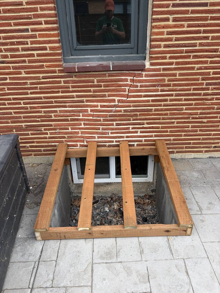 Lumber frame built over a window well