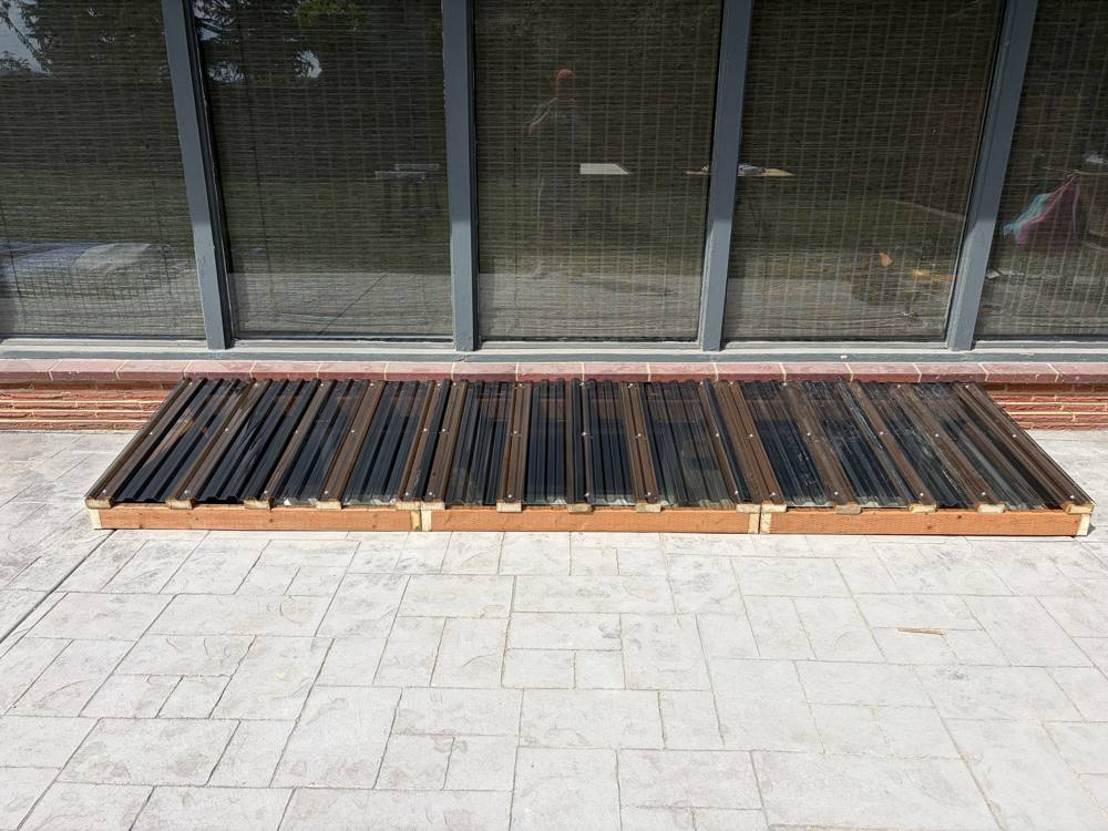 Finished window well covers with clear panels on a wood frame