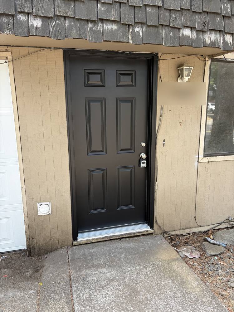 New black six-panel entry door, exterior
