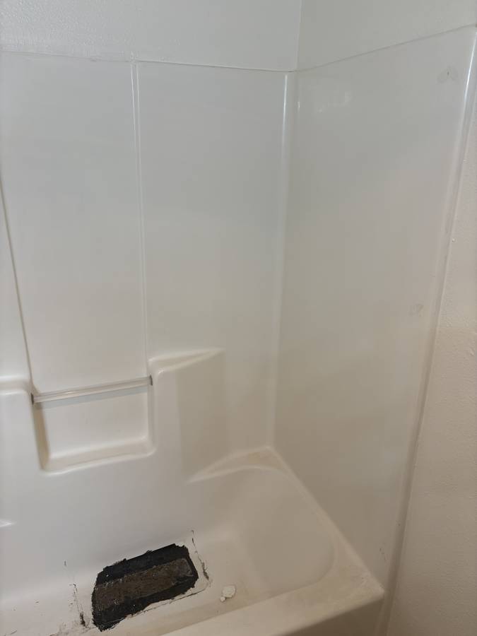 Before: closeup of the patched tub floor