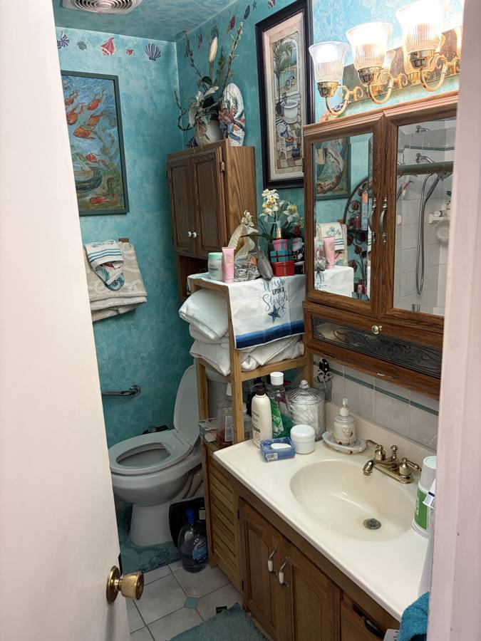 Before: dated bathroom with an old vanity and tub