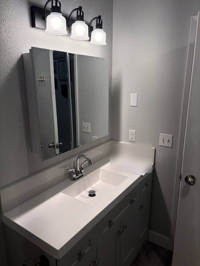 After: new vanity lighting, mirror cabinet and outlets