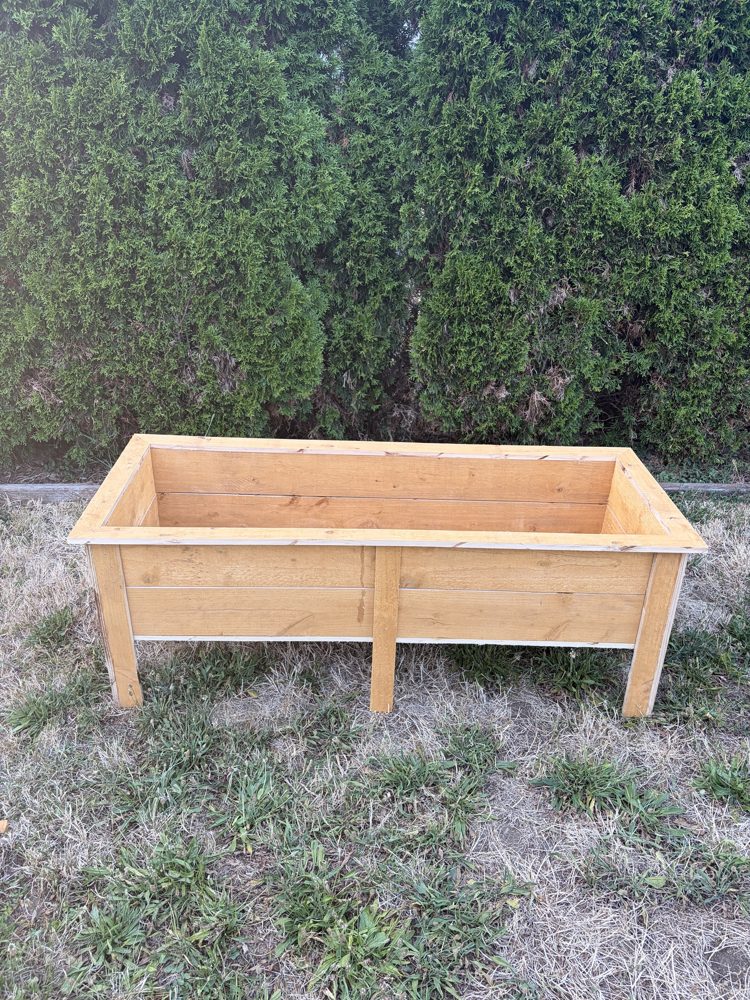 Long handbuilt raised planter box on legs
