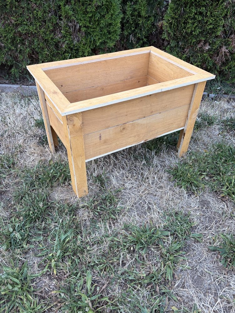 Raised planter box with mitered top trim, angled view