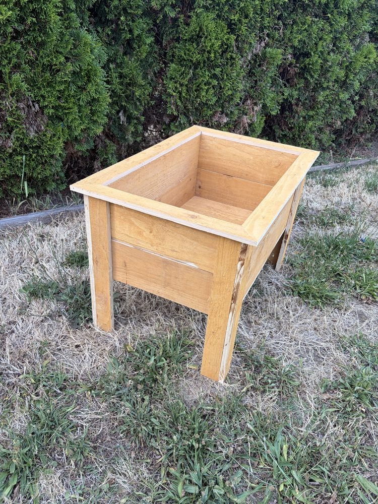 Raised planter box on legs, side angle