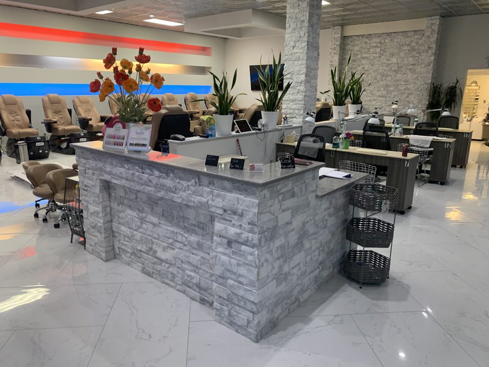 Stacked stone reception desk with a stone countertop in a salon