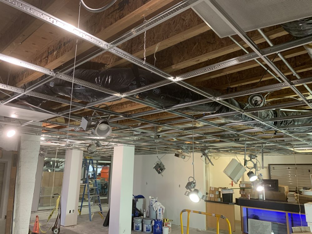 Ceiling grid and recessed lighting going in over a showroom