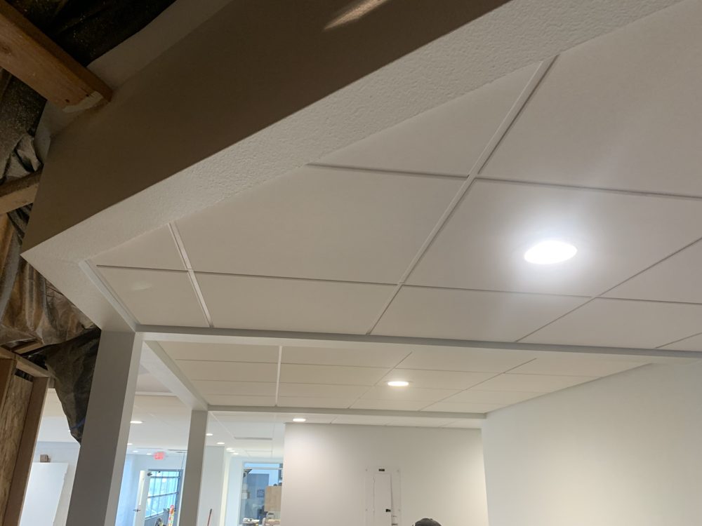 Finished drop ceiling with a trimmed drywall soffit