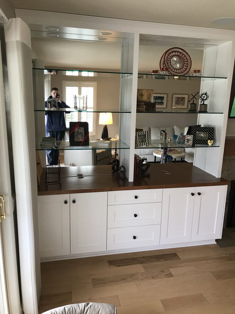 Built-in buffet with drawers, wood countertop, mirrored back and glass shelves